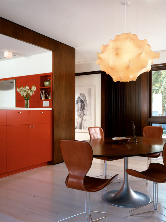 A tree and an orange color in a large spacious kitchen