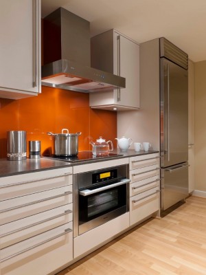 Orange chairs on the background of a wooden kitchen